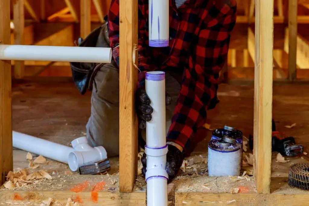 man applying pvc primer to show what happens if you forgot to use primer on pvc